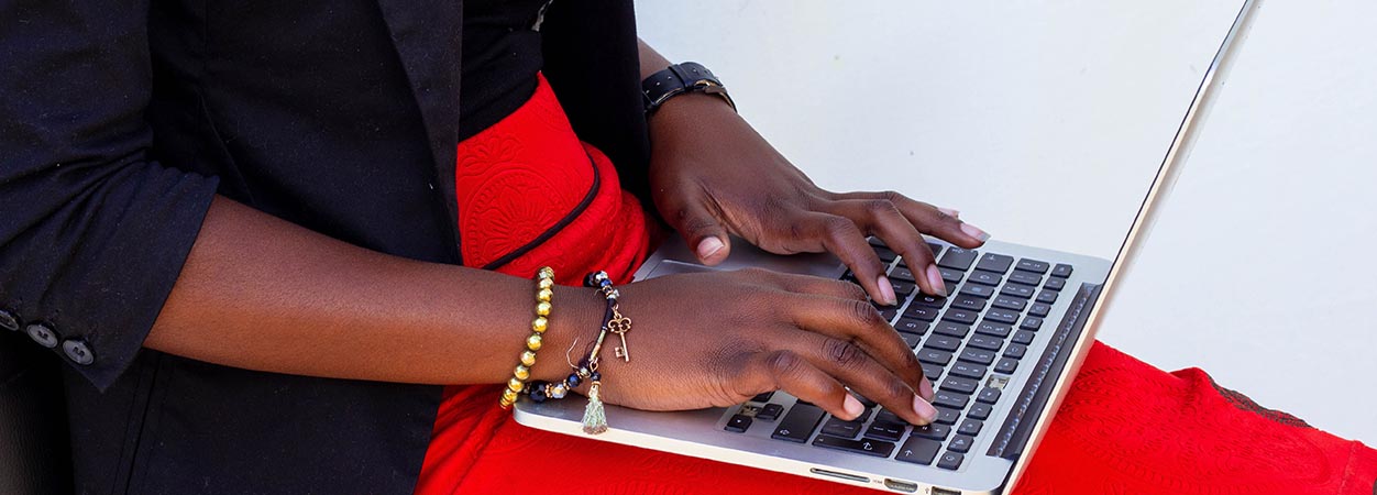 A woman types on a laptop.